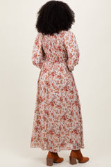 woman wearing a long floral maxi dress with a smocked bodice and puff sleeves, shown from the back