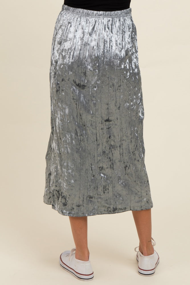 woman wearing a silver velvet maternity maxi skirt with an elastic waistband, shown from the back