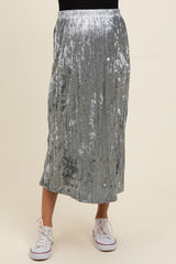 woman wearing a silver pleated maternity skirt and white sneakers with a relaxed fit