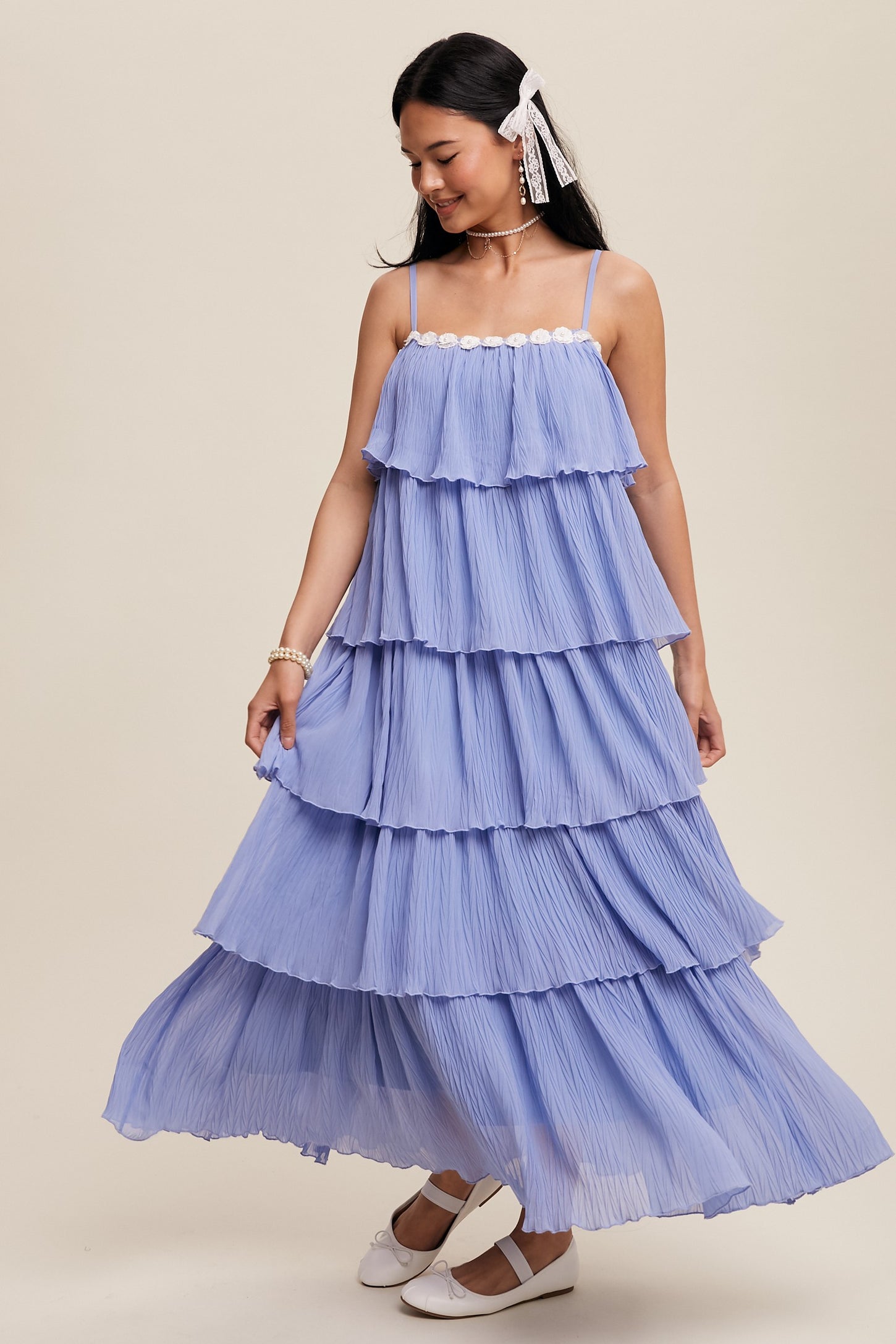 woman wearing a lavender tiered maxi dress with spaghetti straps and a ruffled design