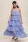 woman wearing a lavender tiered maxi dress with spaghetti straps and a ruffled design