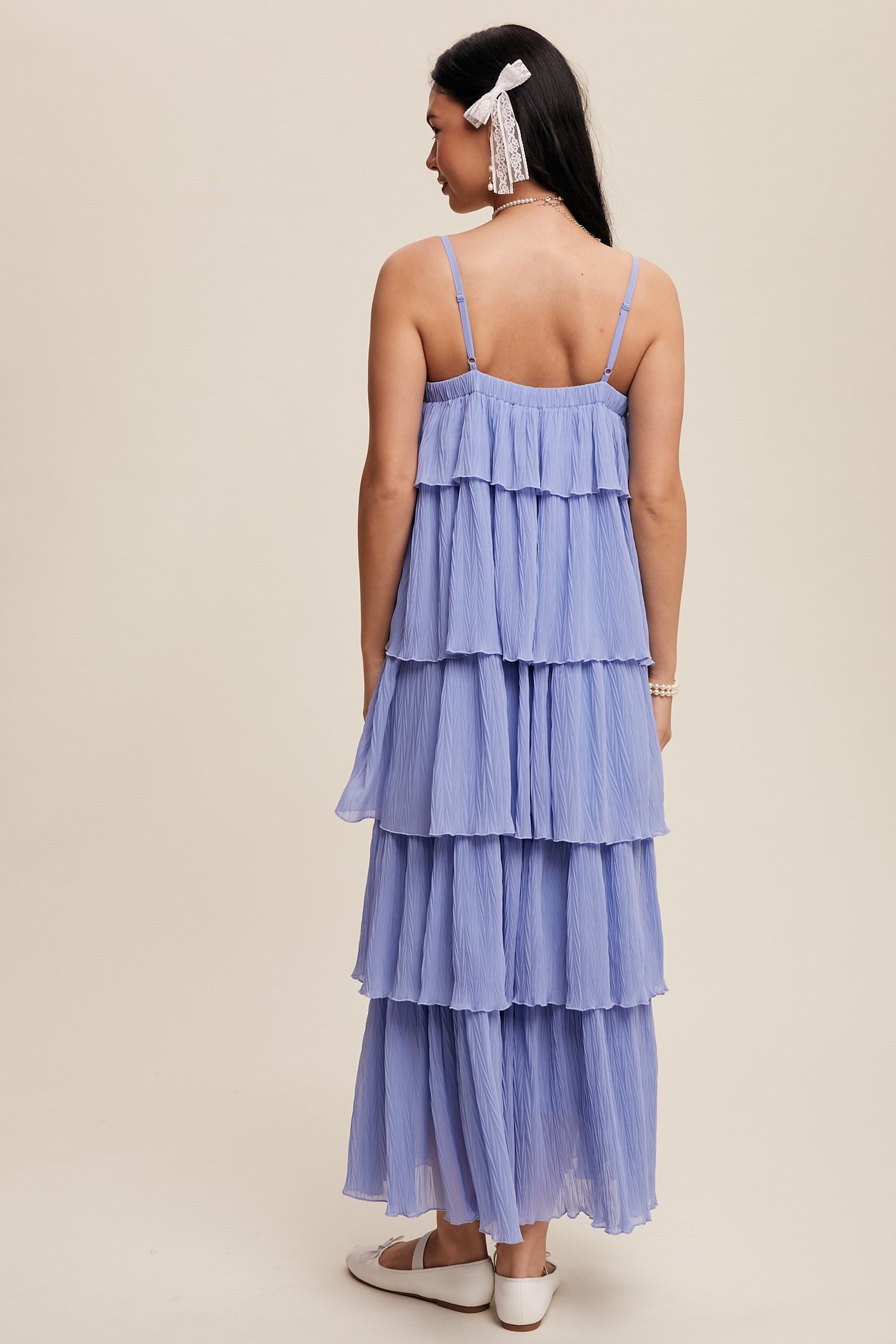 woman wearing a lavender tiered maxi dress with spaghetti straps and a flowing silhouette