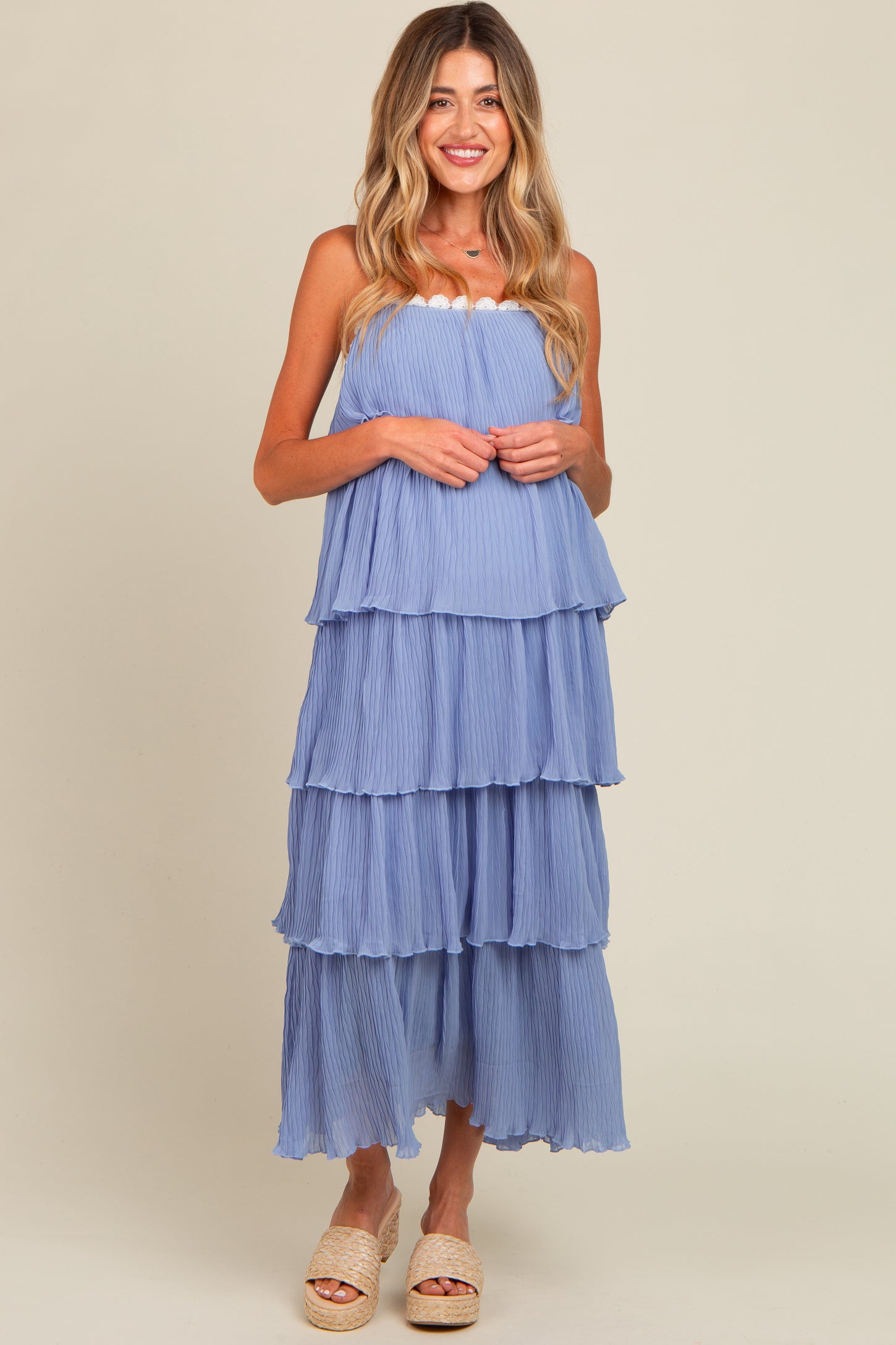 woman wearing a light blue tiered maternity maxi dress with elastic bodice and relaxed fit, showcasing a baby bump