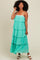 woman wearing a teal tiered maxi dress with spaghetti straps and ruffle details