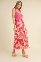 woman wearing a pink ribbed tank top and a long floral tiered maxi skirt with espadrille wedges