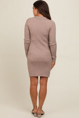woman wearing a light brown ribbed long sleeve maternity dress, shown from the back