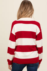 woman wearing a red and white striped maternity sweater, view from the back, paired with blue jeans