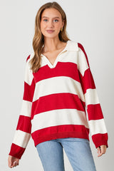woman wearing a red and white striped pullover sweater with a collar and long sleeves, paired with blue jeans
