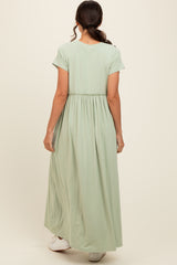 woman wearing a mint green maxi dress with a cinched waist and short sleeves, viewed from the back