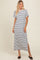 woman wearing a navy and white striped maxi dress with short sleeves and side slits