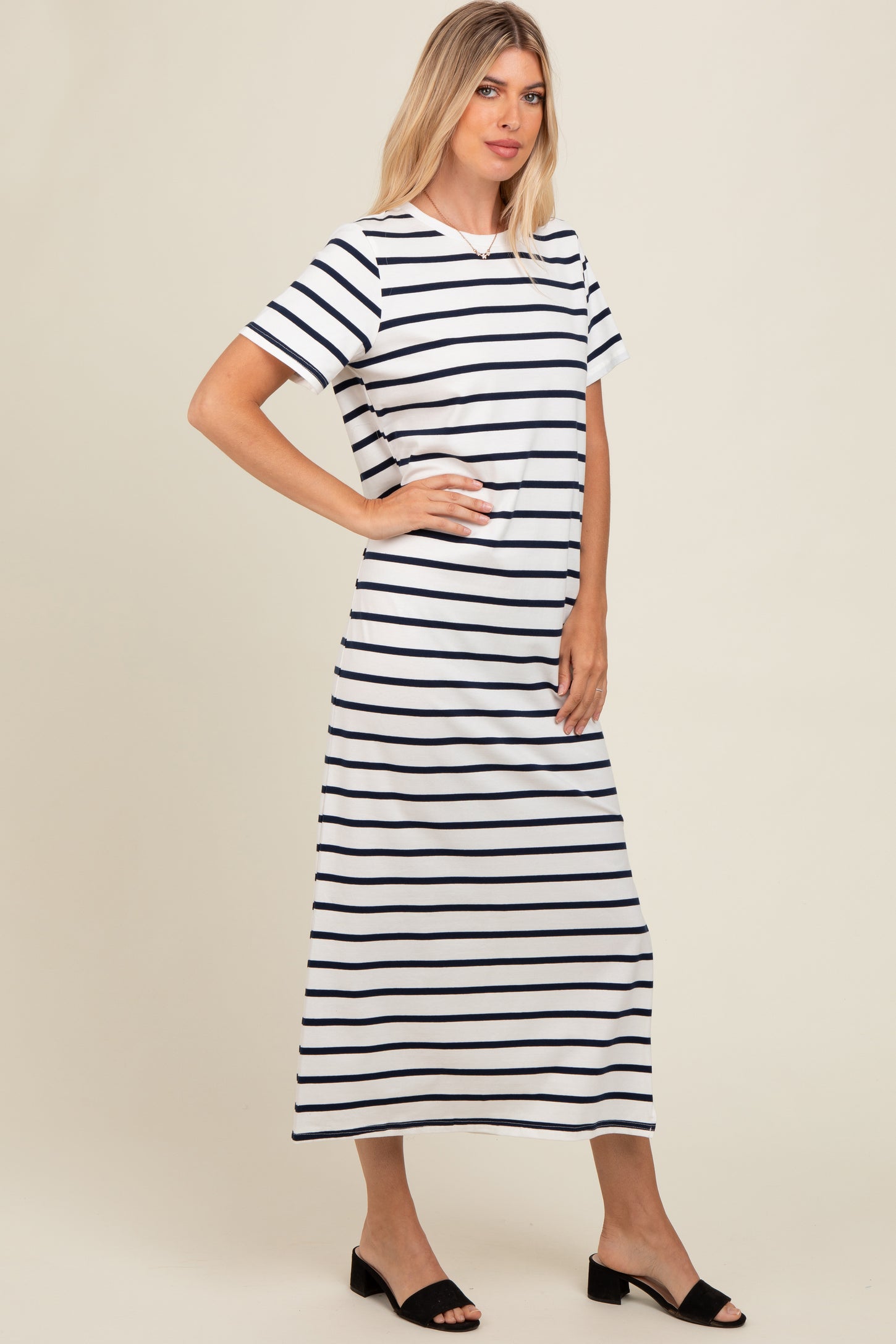 woman wearing a white and navy striped maxi dress with short sleeves and a relaxed fit