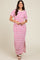 woman wearing a white and pink striped maxi dress with short sleeves and a side slit