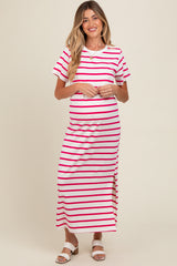 woman wearing a white and pink striped maternity maxi dress with a side slit and holding her baby bump