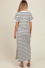 woman wearing a black and white striped maternity maxi dress with short sleeves and a side slit