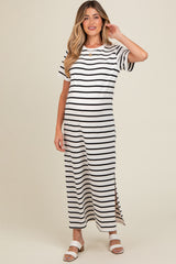 woman wearing a striped black and white maternity maxi dress with short sleeves and side slits, showcasing her baby bump
