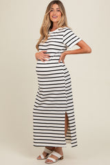 woman wearing a black and white striped maternity maxi dress with side slits and a visible baby bump