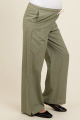 woman wearing olive green checkered maternity wide-leg pants with a drawstring waistband and side pockets