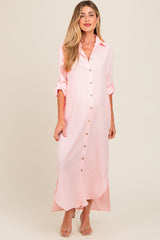 woman wearing a pink and white striped maternity maxi dress with buttons and rolled sleeves, showing her baby bump