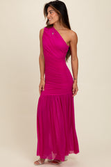 woman wearing a hot pink one-shoulder ruched maxi dress with a flowing skirt and strappy sandals