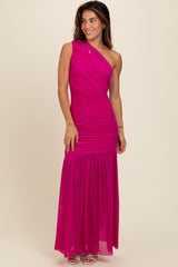 woman wearing a bright pink one-shoulder maxi dress with ruched details and a flowing skirt