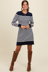 woman wearing a navy and white striped long sleeve sweater dress with brown knee-high boots