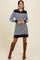 woman wearing a navy and white striped long sleeve sweater dress with brown knee-high boots