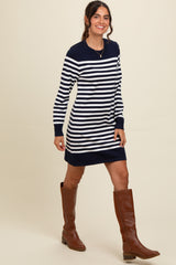 woman wearing a navy and white striped long sleeve sweater dress with a relaxed fit and knee-high brown boots