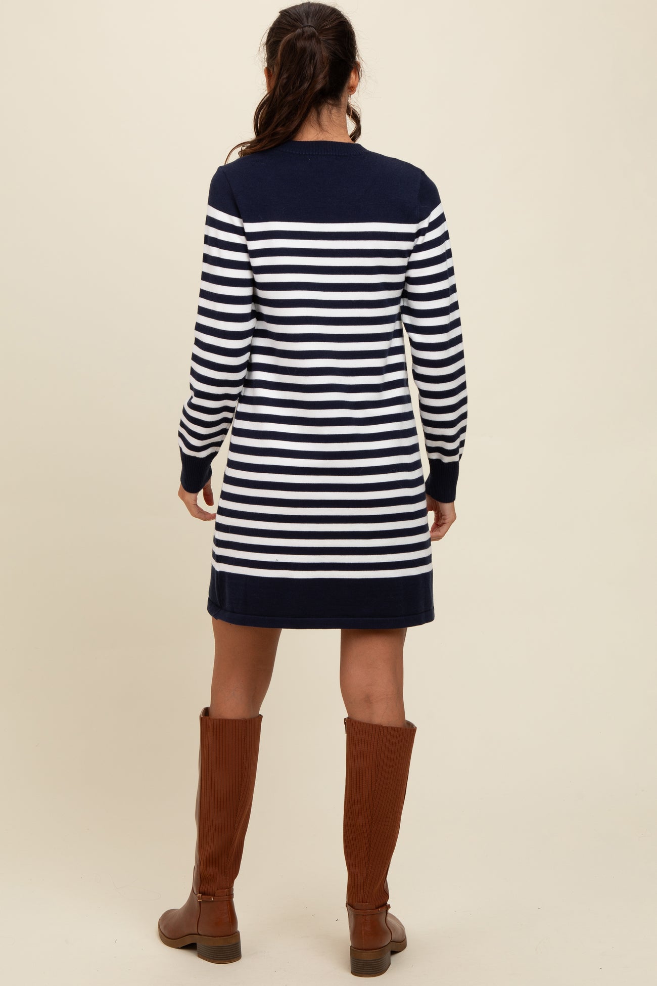 woman wearing a navy and white striped long sleeve dress with a relaxed fit and knee-length hem