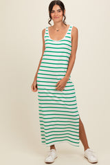 woman wearing a green and white striped maxi dress with a side slit and casual white sneakers