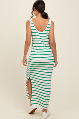 woman wearing a green and white striped maxi dress with a side slit and a scoop back