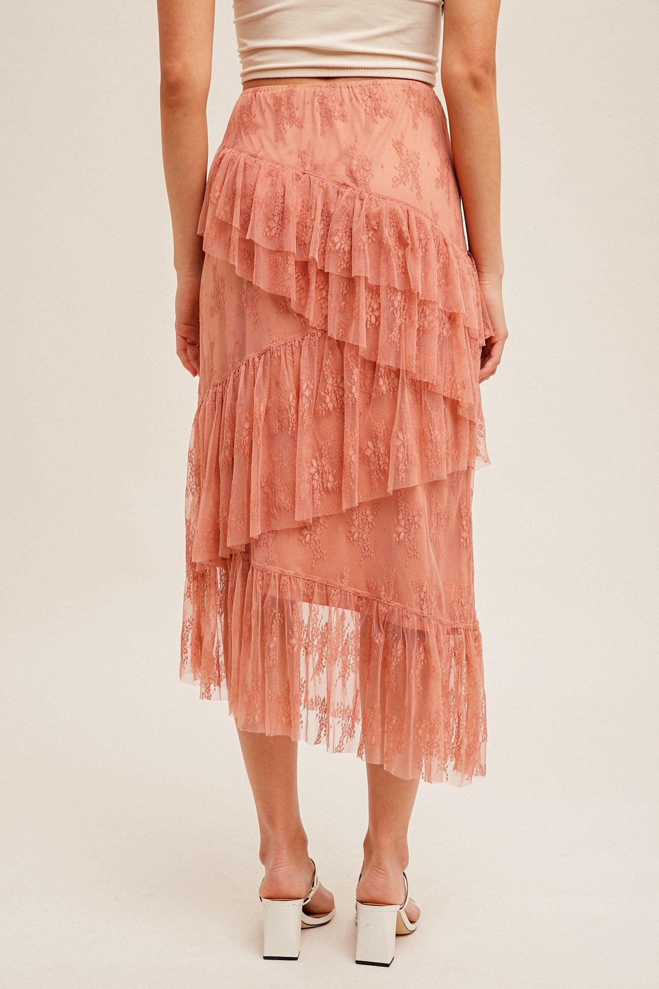 woman wearing a dusty rose layered lace midi skirt with ruffles and a scalloped hem