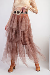 woman wearing a flowy brown layered tulle skirt with a wide belt and tan heeled sandals