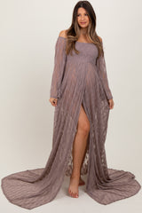 woman wearing a mauve off-the-shoulder lace maternity gown with long sleeves and a thigh-high slit, showcasing her baby bump