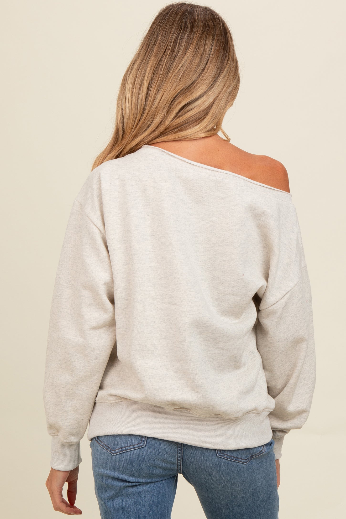 woman wearing a grey off-the-shoulder maternity sweatshirt with relaxed fit and long sleeves