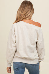 woman wearing a grey off-the-shoulder maternity sweatshirt with relaxed fit and long sleeves