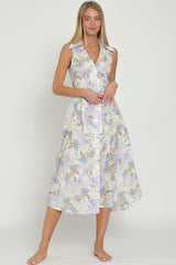 woman wearing a sleeveless lavender floral midi dress with a collared neckline and button details