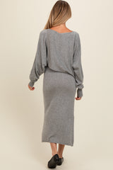 woman wearing a gray long sleeve maternity dress with a loose fit and mid-calf length, showing her back
