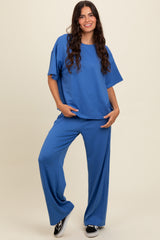 woman wearing a blue cozy two-piece set featuring a short-sleeve top and wide-leg pants