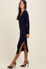 woman wearing a navy ribbed long sleeve dress with a side slit and paired with black high heels