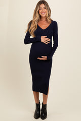 woman wearing a navy blue ribbed long sleeve maternity dress and holding her baby bump
