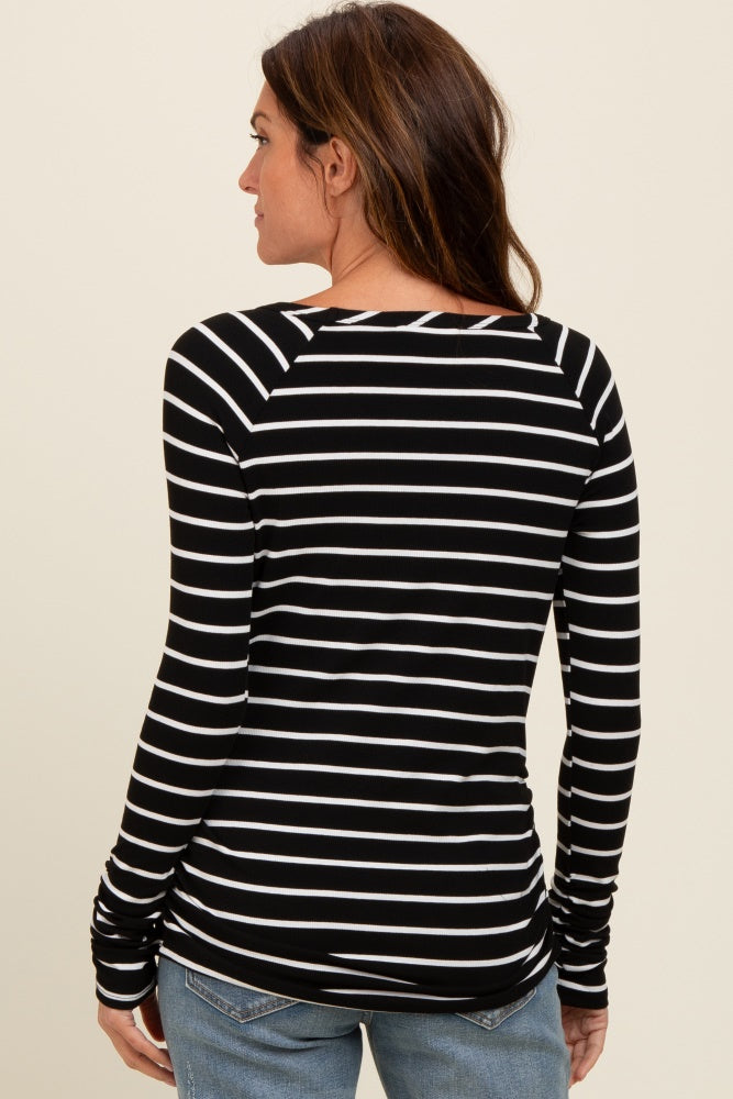 woman wearing a black and white striped long sleeve top, displaying the back view with fitted design and crew neckline