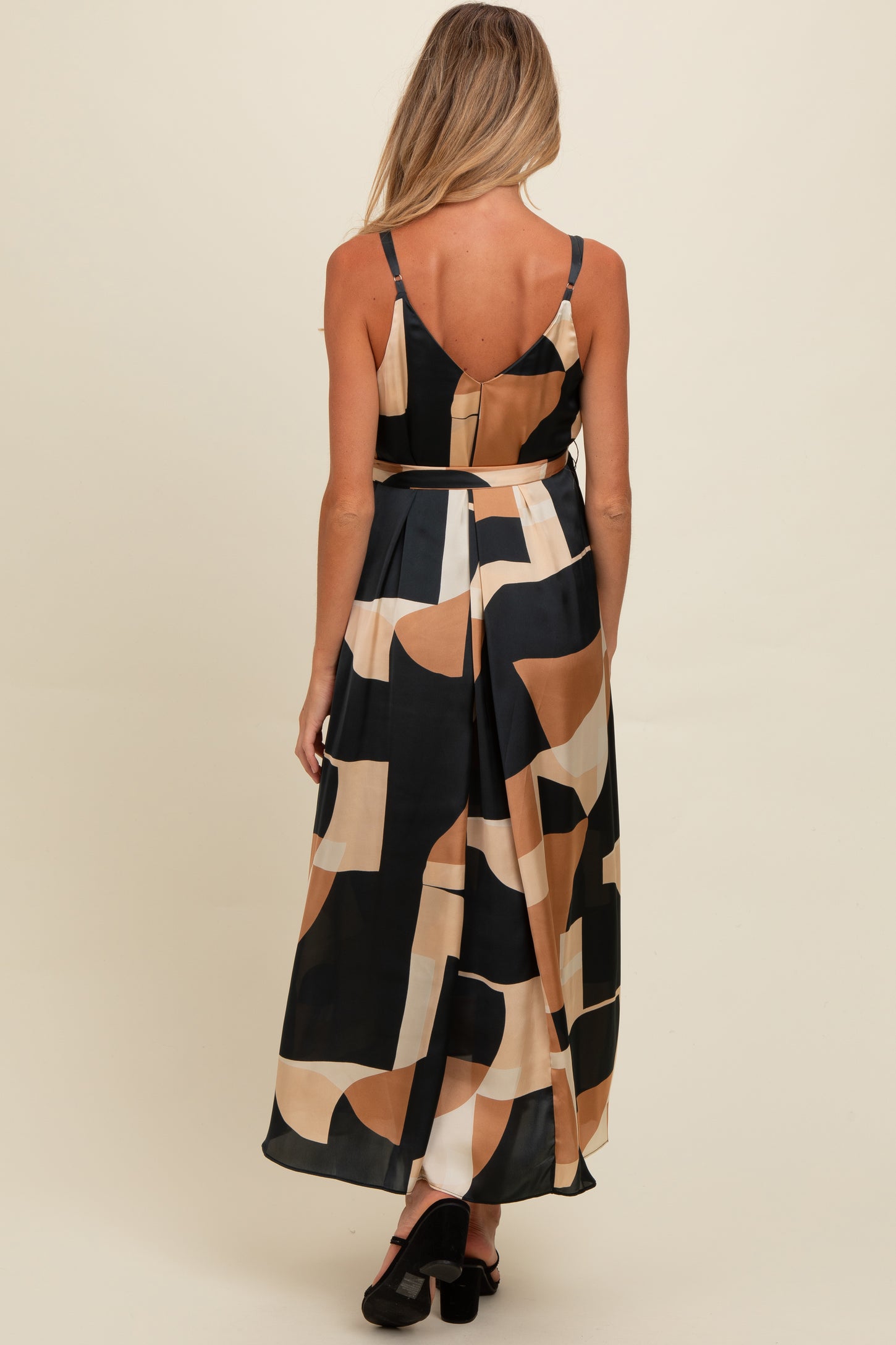 woman wearing a black and beige patterned maternity maxi dress with spaghetti straps, showing a comfortable fit