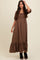woman wearing a brown floral maxi dress with puff sleeves and a ruffled hem