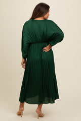 woman wearing a long green pleated maternity dress, showing a relaxed fit and beautiful draping at the back