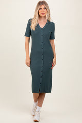 woman wearing a teal ribbed midi dress with short sleeves and button details, paired with white sneakers