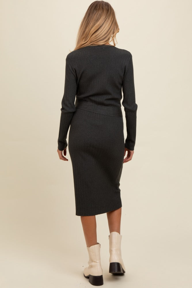 woman wearing a dark gray ribbed maternity dress with a fitted silhouette and long sleeves, viewed from the back