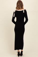 woman wearing a black long sleeve maxi dress with light pink bow accents on the shoulders, seen from the back