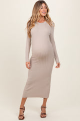 woman wearing a nude long sleeve ribbed maternity dress showcasing her baby bump