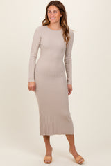 woman wearing a beige long sleeve ribbed midi dress and beige sandals