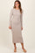 woman wearing a beige long sleeve ribbed midi dress and beige sandals